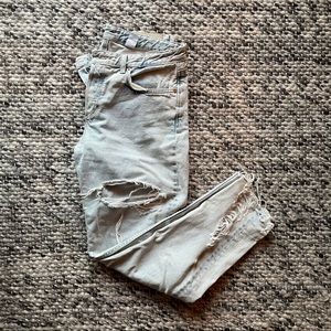 Light wash, ripped, raw hem, button fly jeans